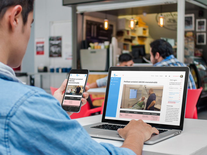 iphone-and-macbook-mockup-of-a-young-man-at-the-cafeteria-a4635